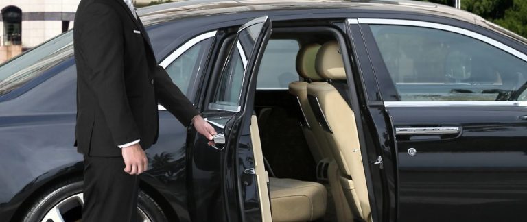 A professional chauffeur in a dark suit